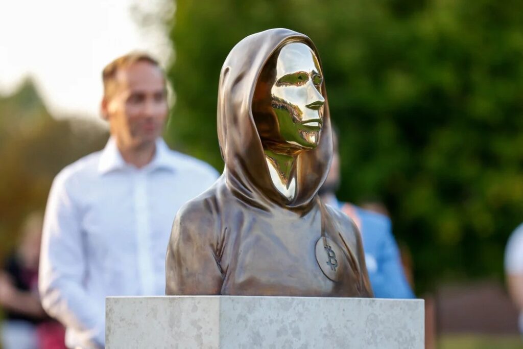 Statue of Satoshi Nakamoto in Budapest, featuring a hooded figure with a reflective face that symbolizes anonymity – The Coinomist