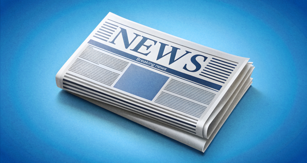 Folded newspaper with 'Breaking News' headline on a blue background - The Coinomist