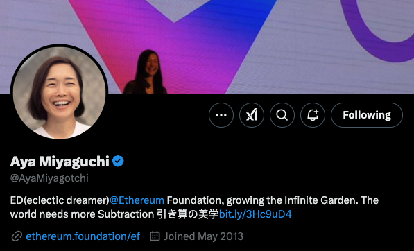 Aya Miyaguchiβs X profile with a smiling profile picture and a cover photo of her speaking on stage - The Coinomist