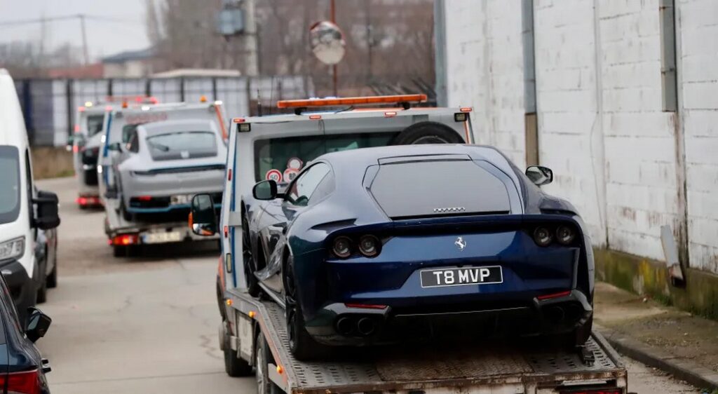 Andrew Tate claims to own nothing but cars. Pictured: Romanian police confiscating supercars from Tate’s collection - The Coinomist