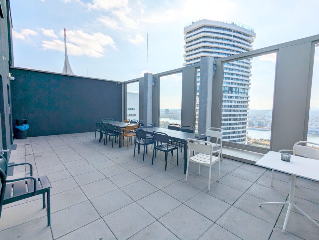 Rooftop Web3 Hub Vienna above the DC Tower skyline – The Coinomist
