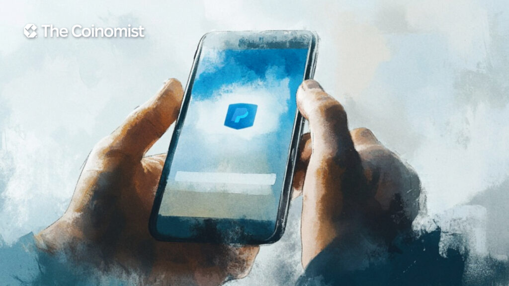 A mobile phone displaying the PayPal logo on its screen. - The Coinomist