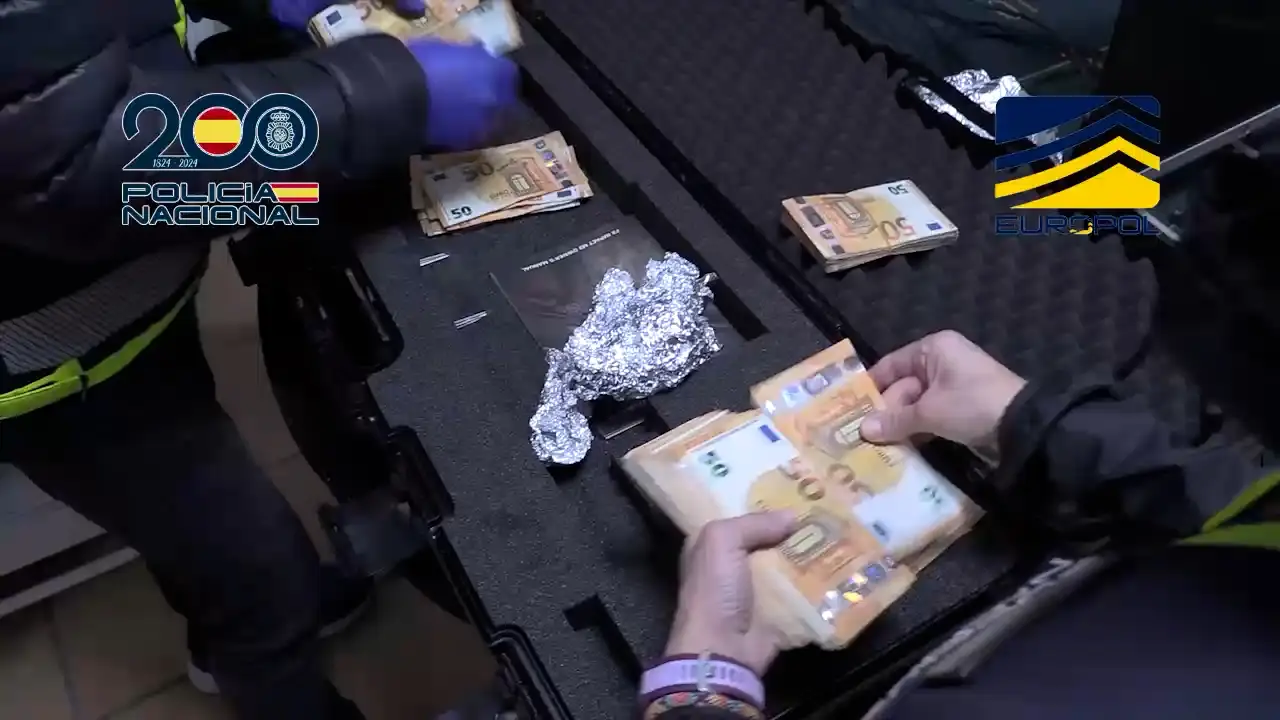 Police officer counting seized euros — The Coinomist.