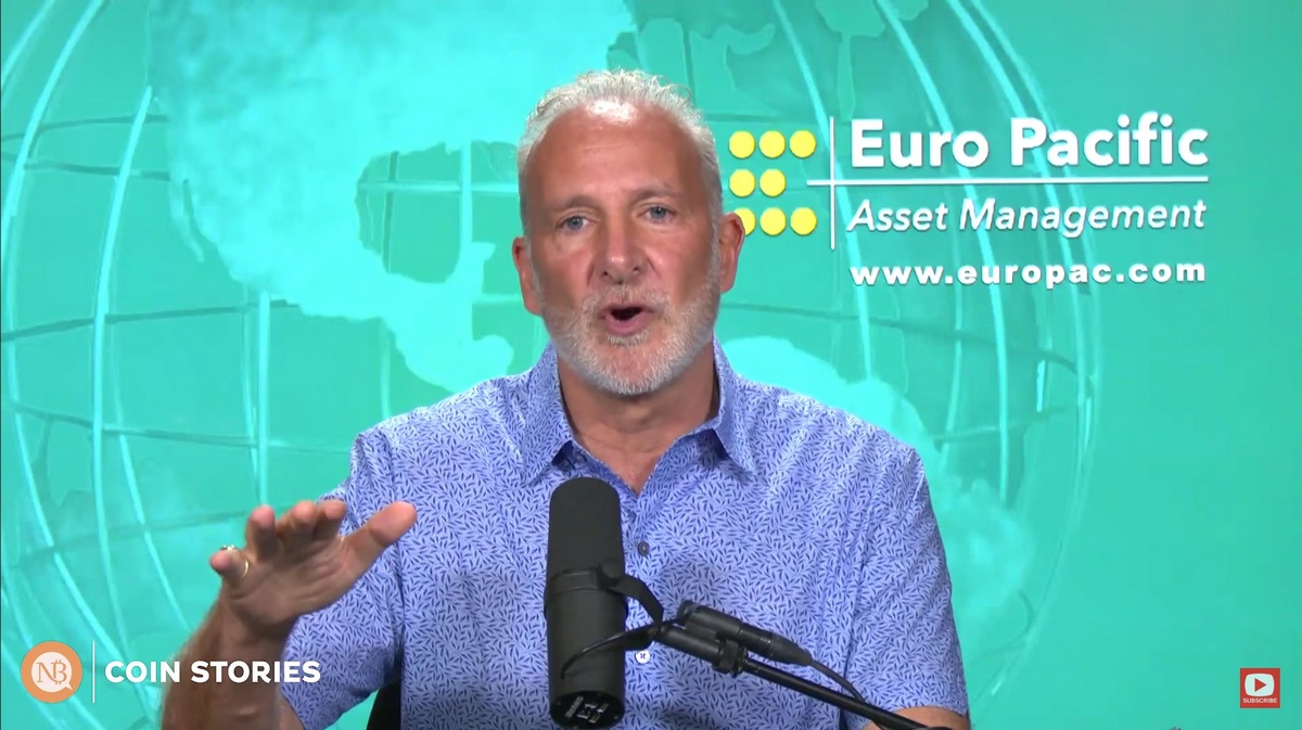 Peter Schiff in a patterned shirt speaking into a microphone with a turquoise globe and Euro Pacific logo in the background — The Coinomist.