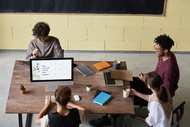 A symbolic scene of digital designers aligning ideas — a nod to the spatial logic and narrative flow behind immersive metaverse experiences. — The Coinomist