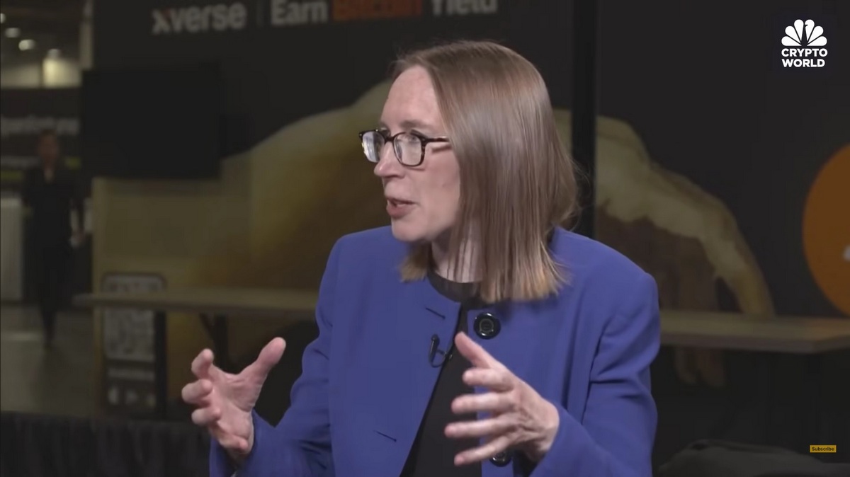 Hester Peirce gesturing mid-sentence in a blue blazer during an interview — The Coinomist